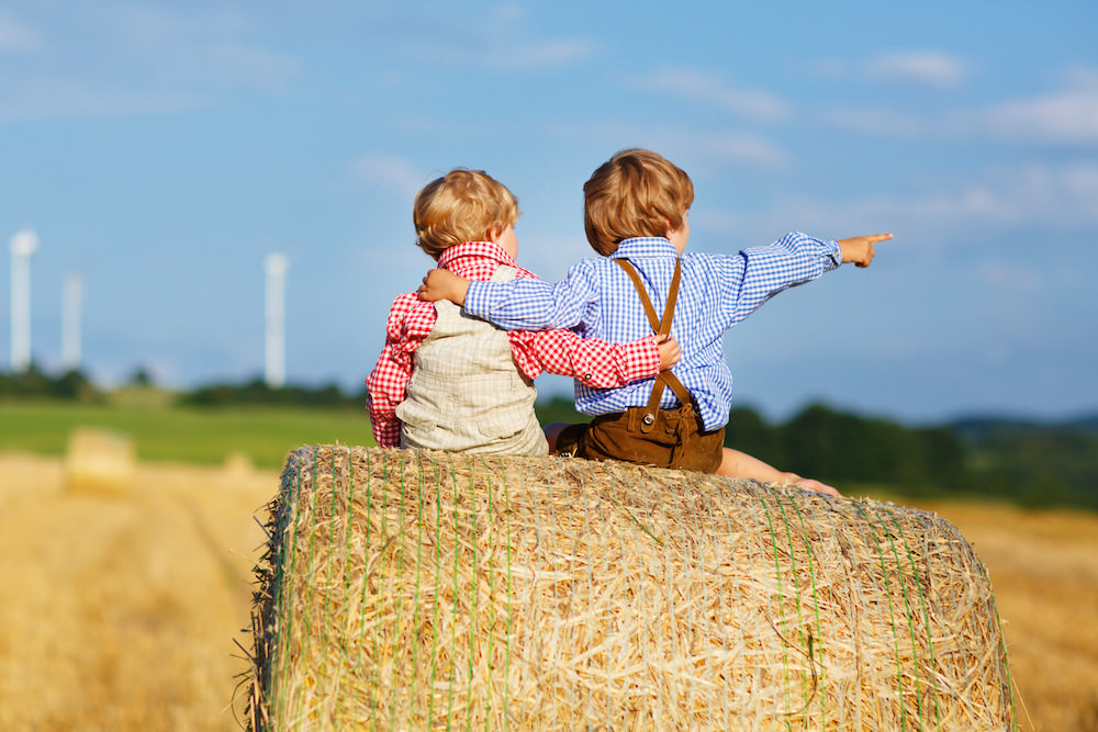 Brothers sitting on a hay block for vacation photo