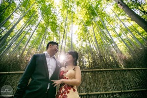 A couple looking at each other romantically in the bamboo grove in Arashiyama, Kyoto