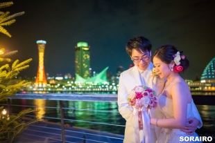 A couple posing in front of the camera with beautiful night view of Kyoto for pre-wedding photo