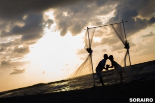 A couple kissing on the beach during sunset