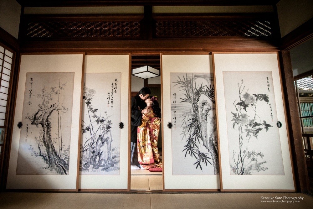 A couple kissing wearing a beautiful kimono in an authentic Japanese house for pre-wedding photo