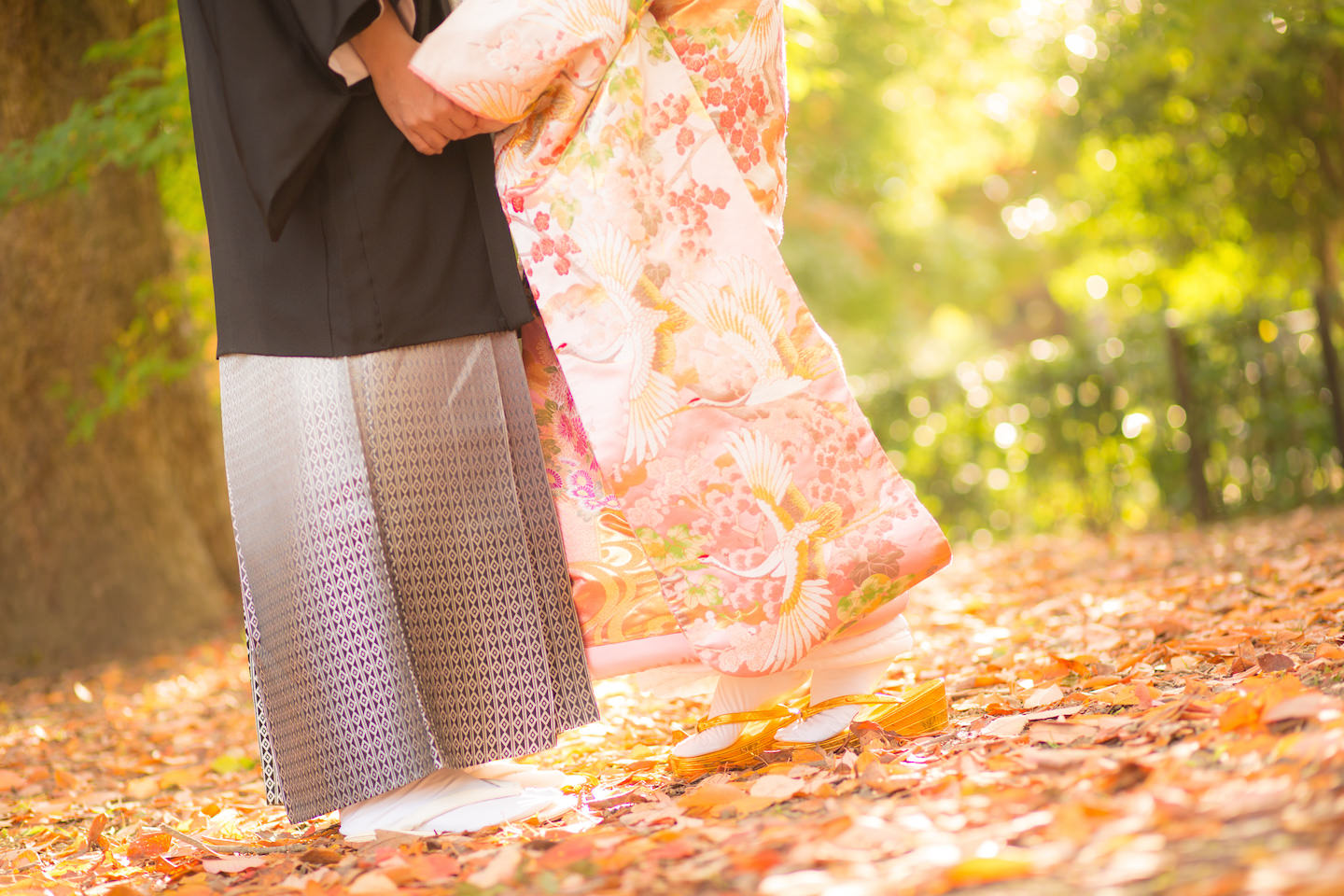 A couple holding hands wearing kimono with woman on toes