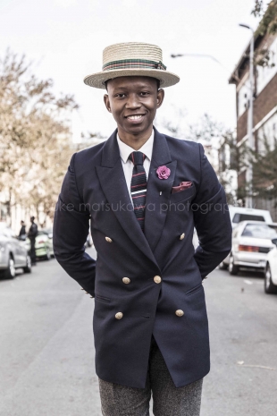 A man dressed in suite in the middle of the street