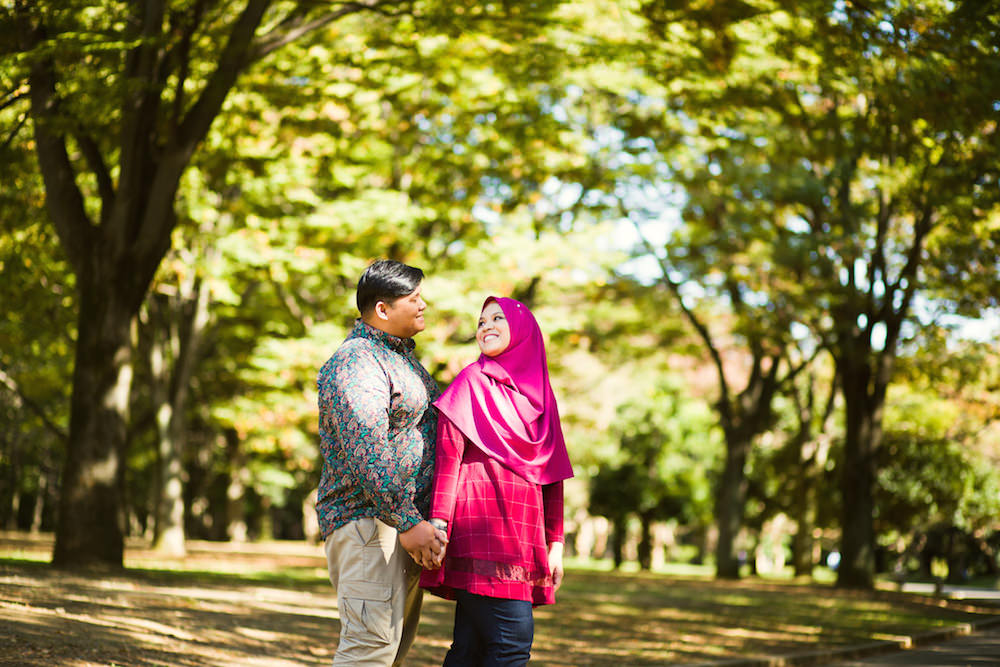 Vacation photo of a couple smiling at each other at Yoyogi park, Tokyo