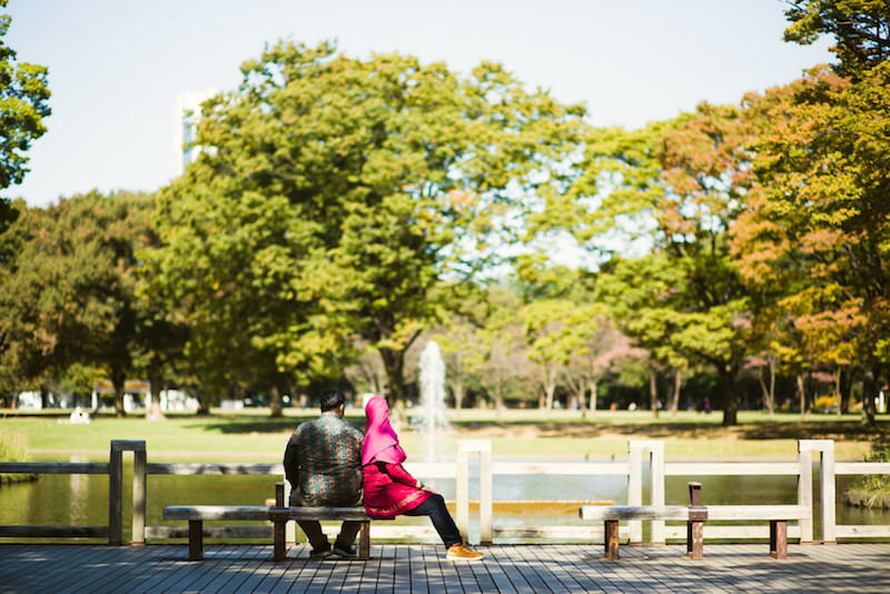 Vacation photo of a couple relaxing at Yoyogi park, Tokyo
